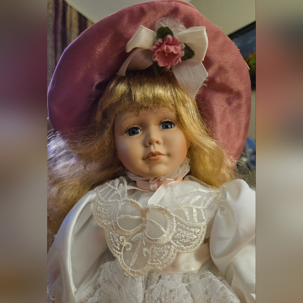 Delicate porcelain doll dressed in pink & white